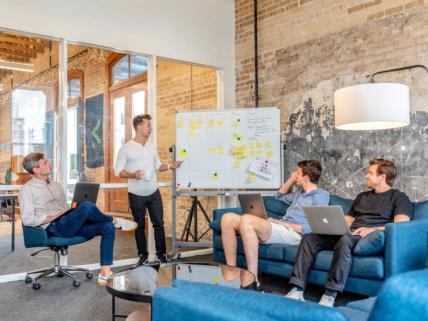 Team collaborating around a project board in a bright modern office