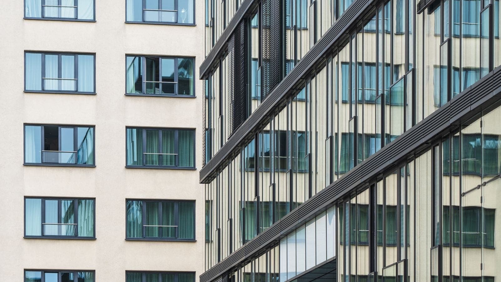 Modern mixed-use office and residential buildings with glass facades in an urban setting