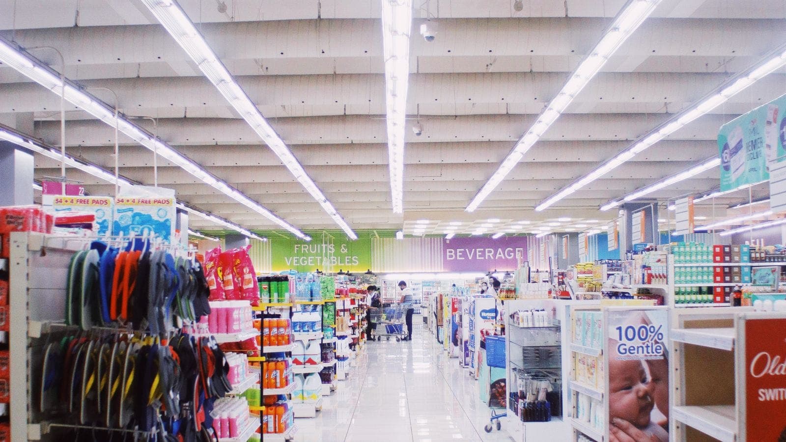 Wide aisle inside a modern supermarket with brightly stocked shelves